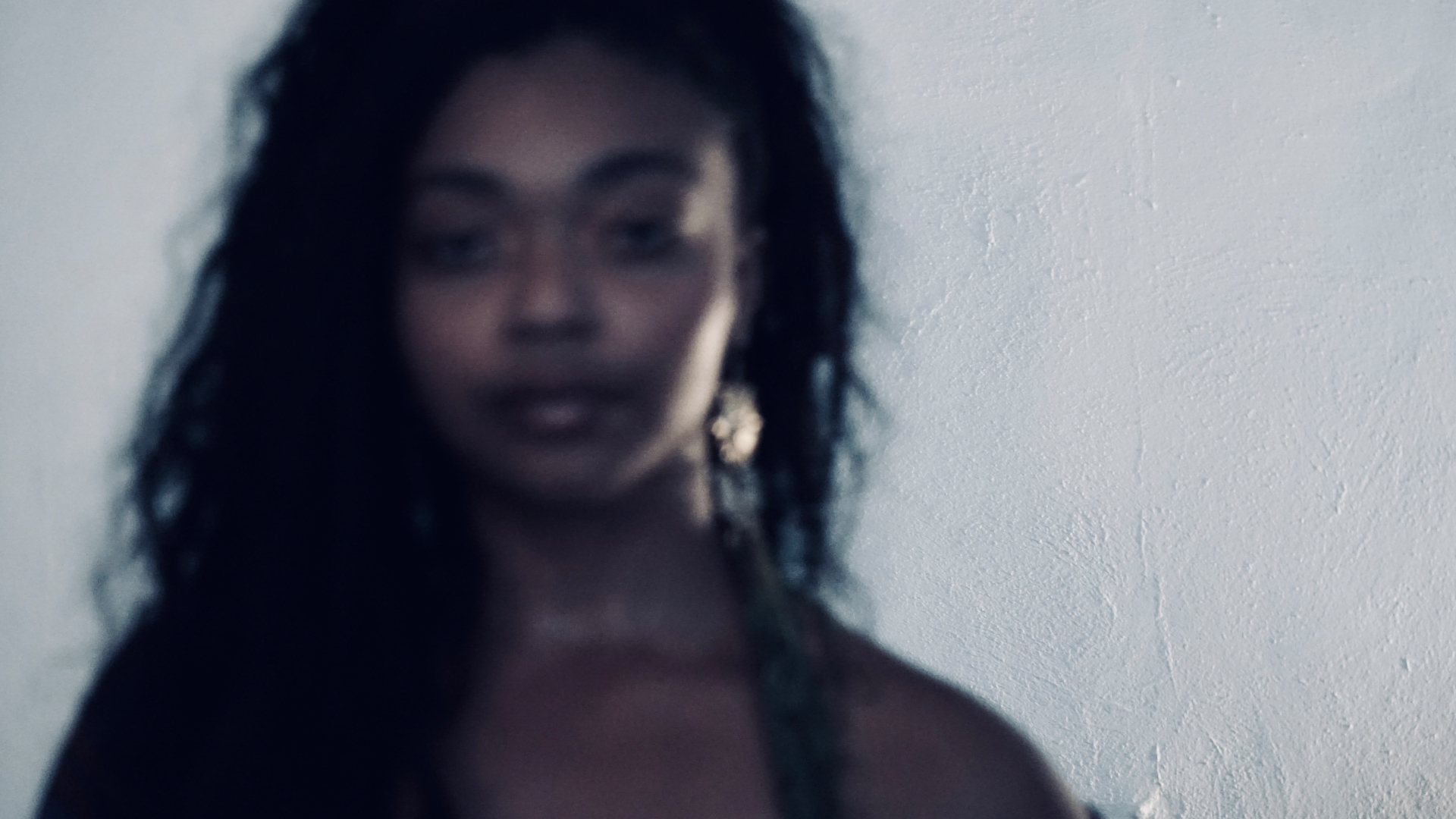 Close portrait of Aaniyah, eyes lowered, soft focus