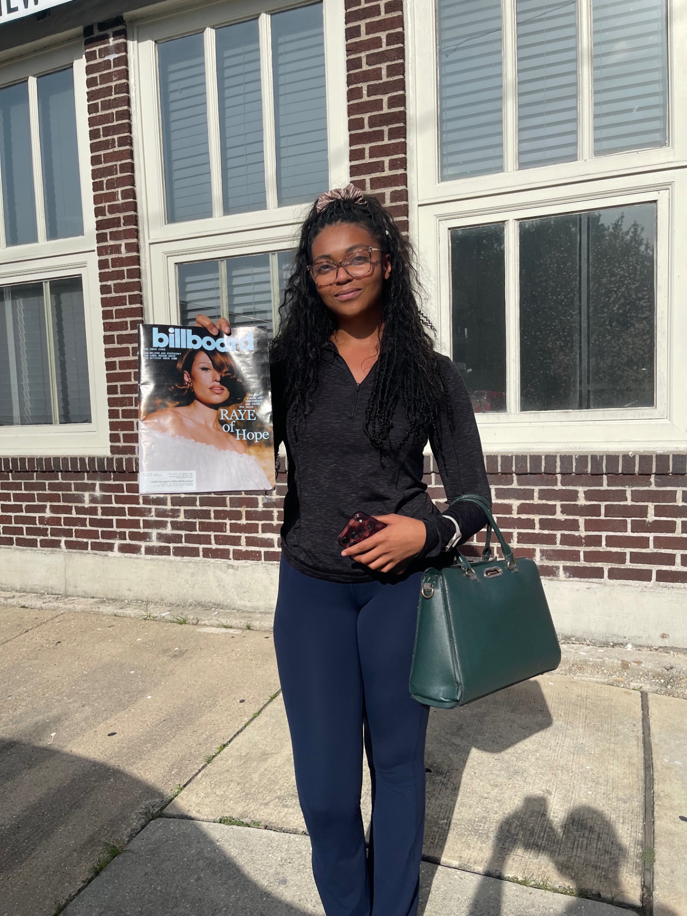 Plate 06 — Young woman holding a Billboard cover · Raye of Hope