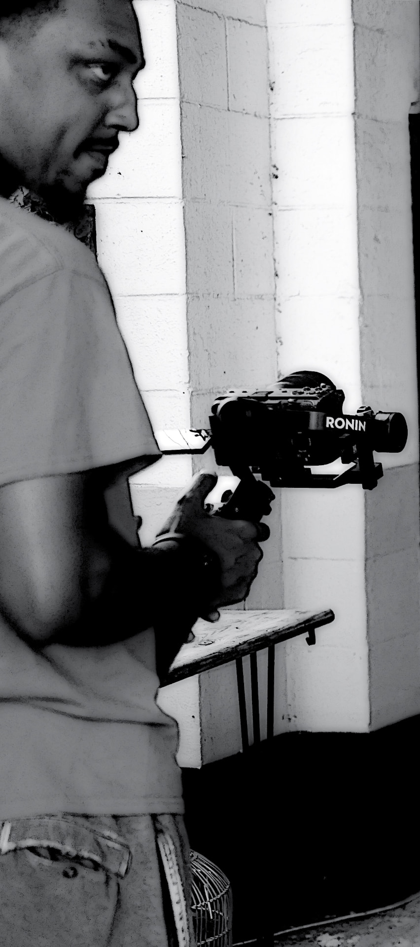 Camera operator with a Ronin gimbal rig framing a shot in black and white on the Have It Your Way set