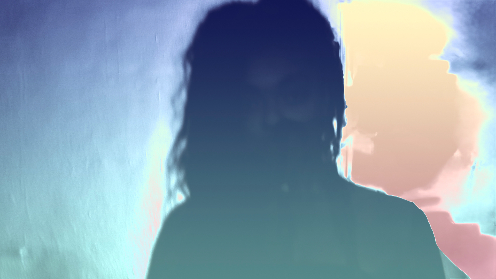 Solarized frame of Aaniyah facing the wall, colors inverted