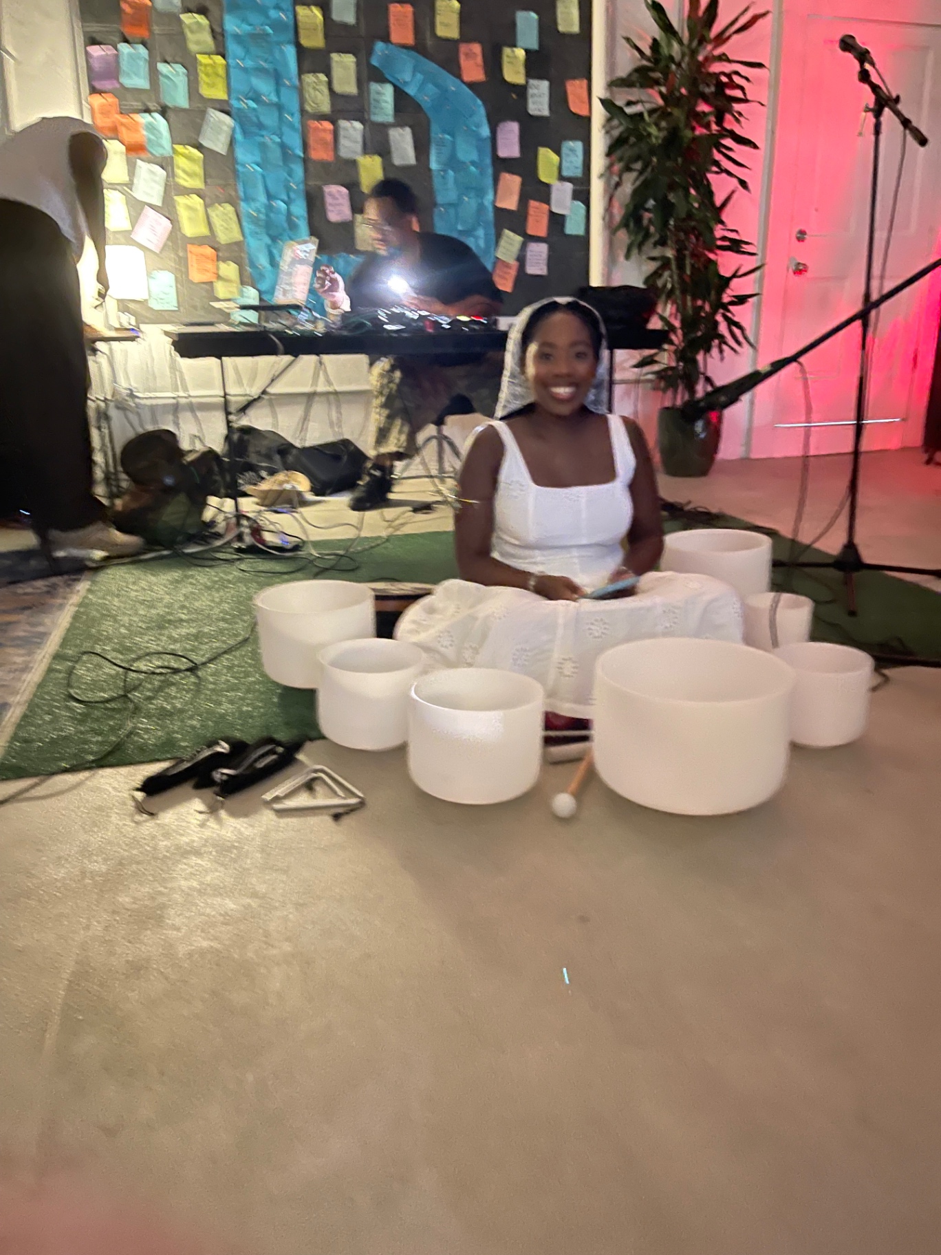 Plate 03 — Crystal singing bowls · white dress · DJ rig · sticky-note wall
