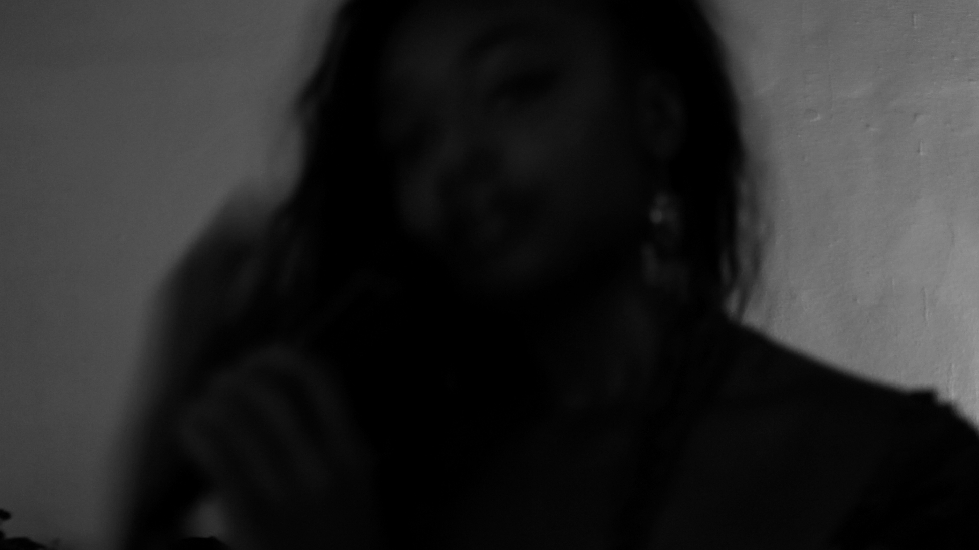 Black and white frame of Aaniyah laughing in the booth
