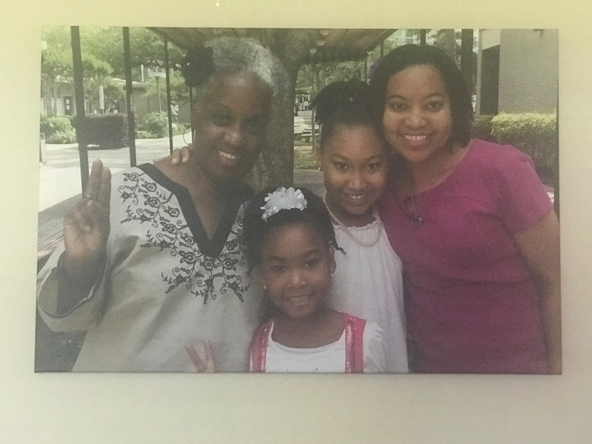 A framed family photograph of Momma Peggy with her daughter and two granddaughters.