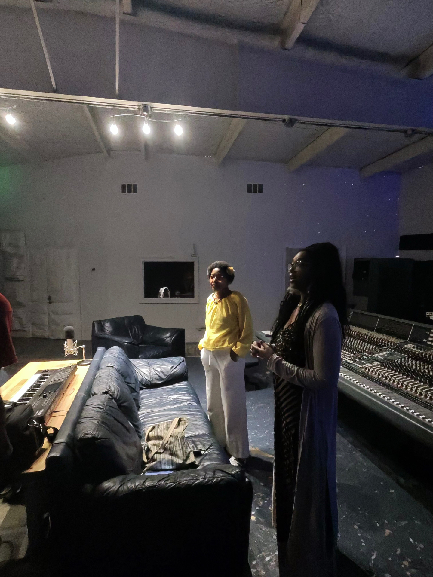 Aaniyah at The Box Studios, standing at the console during a session